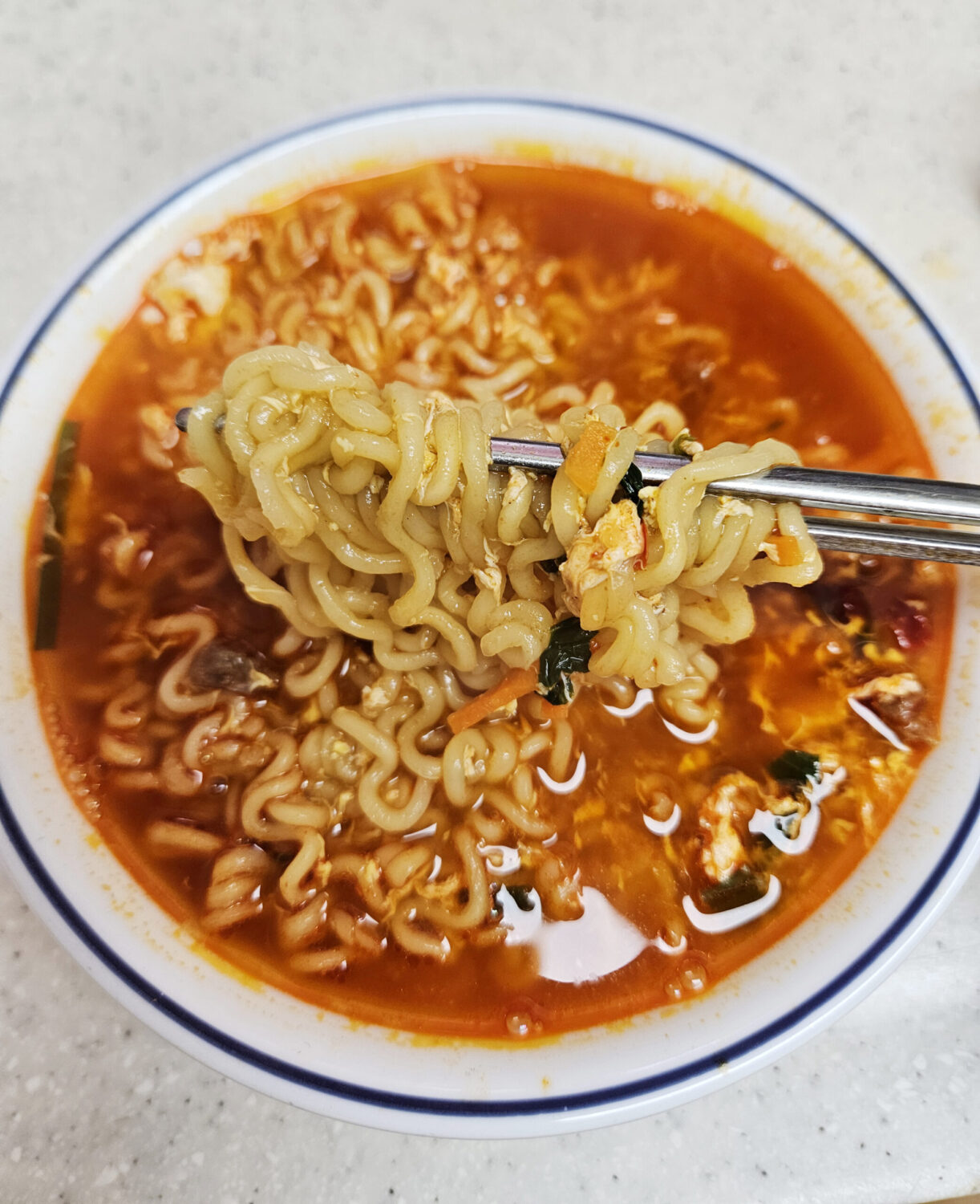 Yeol Ramyeon The Red with a soft-boiled egg in the spicy broth