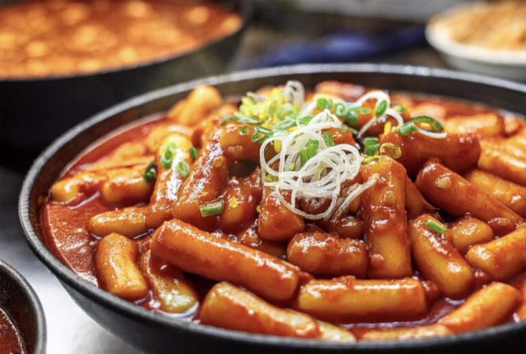 Tteokbokki – Korea’s iconic street food made of chewy rice cakes and spicy-sweet gochujang sauce.